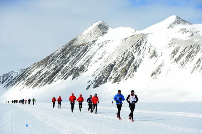 A group of runners complete an ice marathon across antarctica