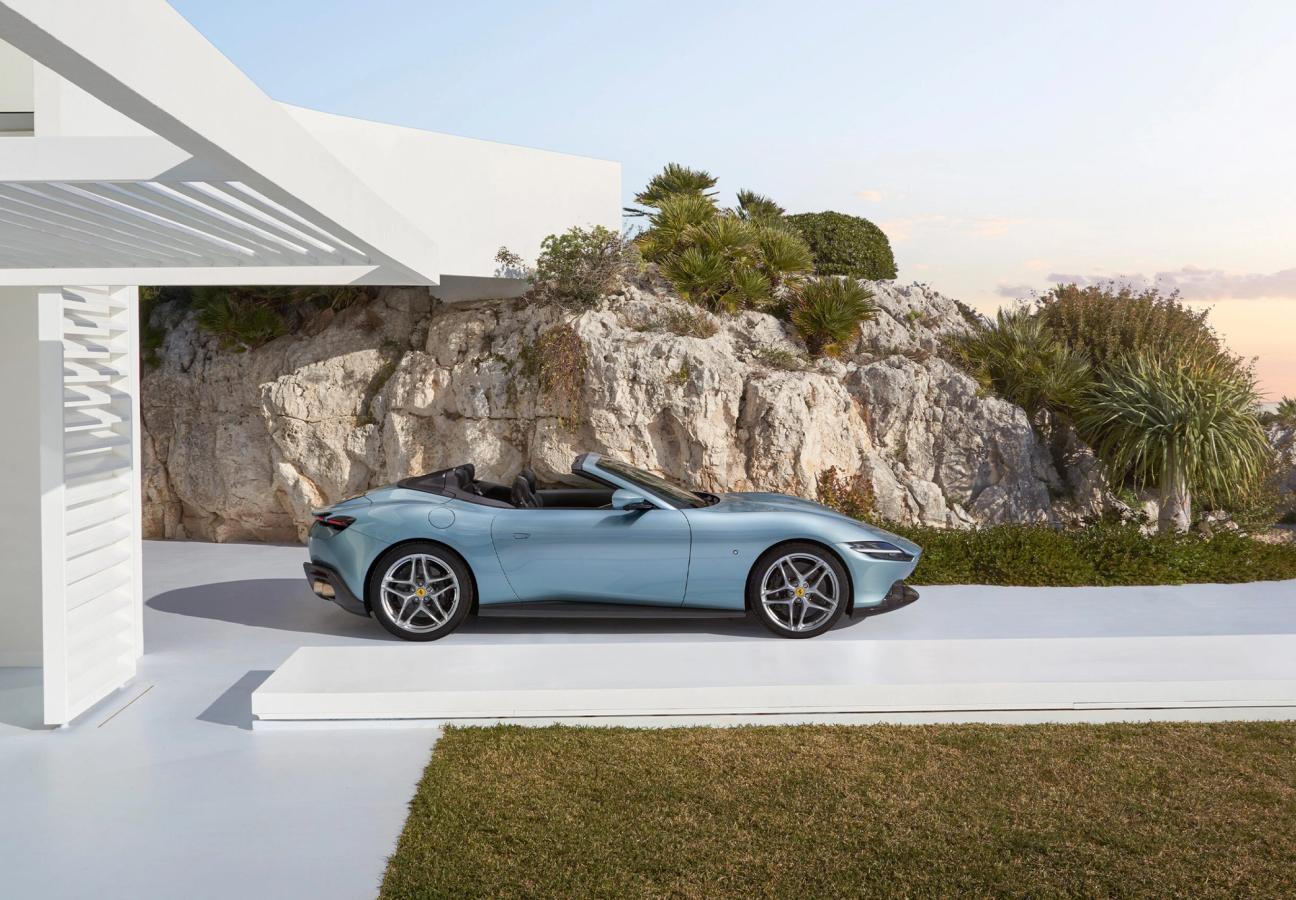 Side profile of Ferrari Roma Spider, pulling out of the coastal driveway