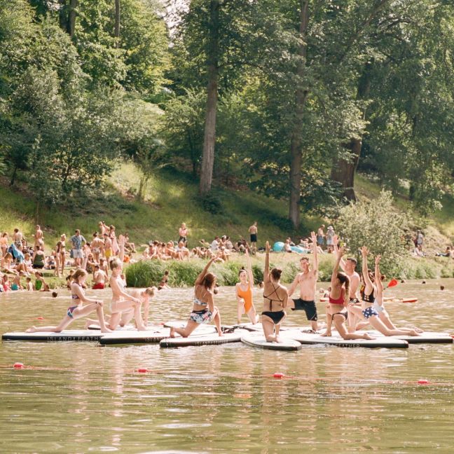 A Paddleboard Yoga session taking place on paddle boards on the lake