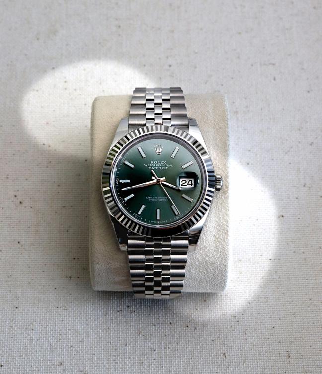 Rolex watch with green watch face