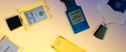 Scattered fragrance bottles including Acqua di Parma, Tom Ford Neroli Portofino and Creed Erolfa
