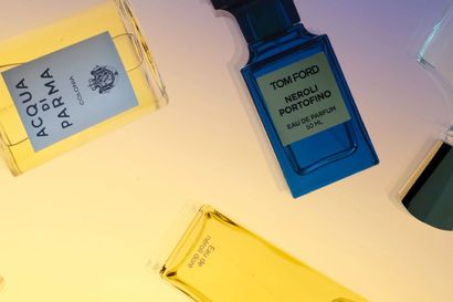 Scattered fragrance bottles including Acqua di Parma, Tom Ford Neroli Portofino and Creed Erolfa
