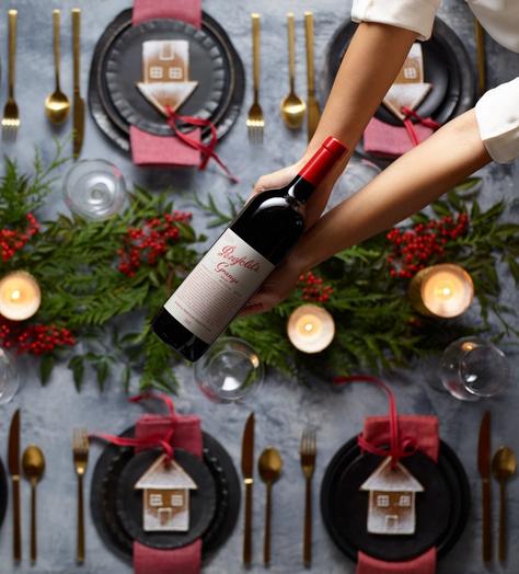 Bottle of Penfolds held over the Christmas table