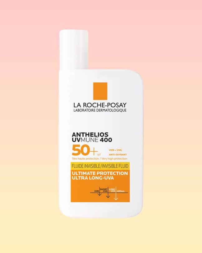 La Roche-Posay Anthelios UVMune 400 Invisible Fluid SPF50+ bottle on a pink and yellow background