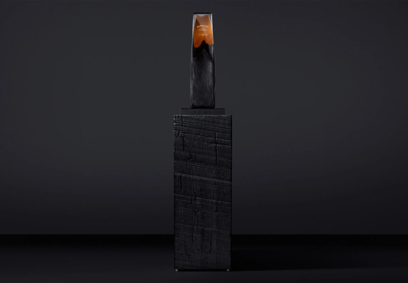 Bowmore 55-year-old Whisky in a glass bottle designed to resemble a rock formation