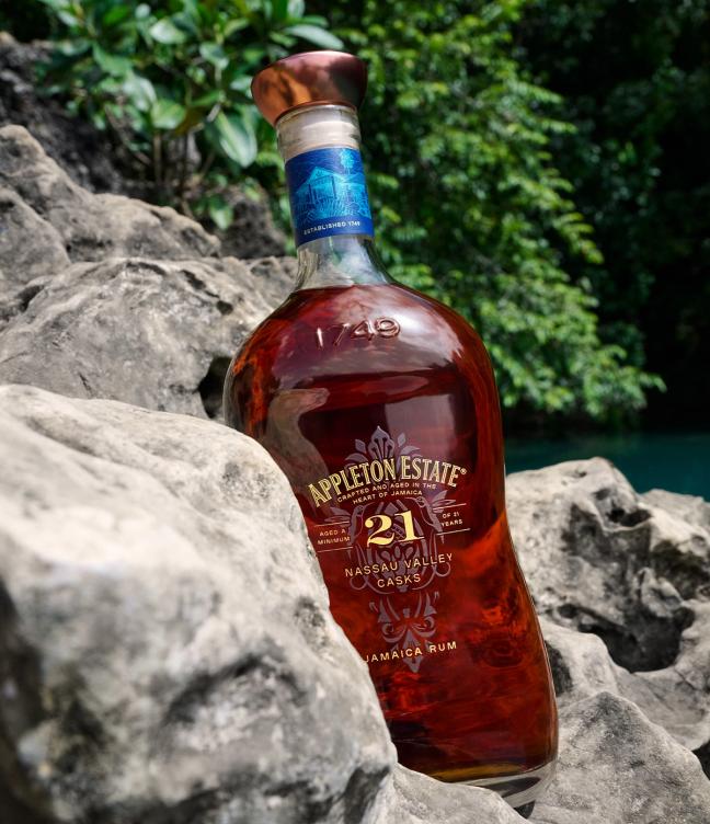 Appleton Estate 21 Nassau Valley Casks bottle of rum on rocks next to a river