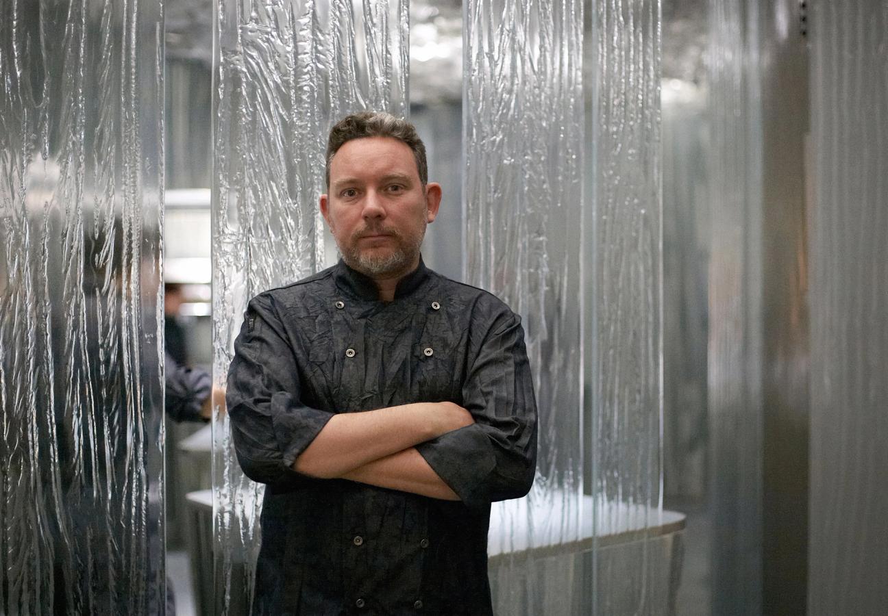 Chef Albert Adria standing in his restaurant Enigma