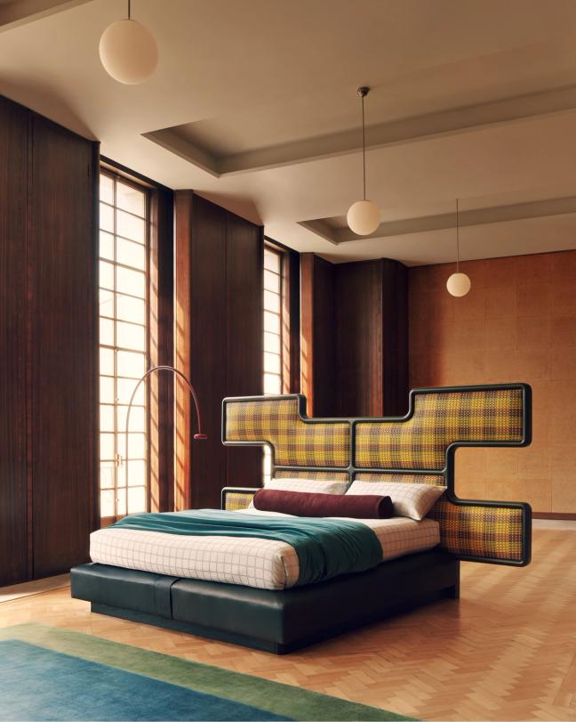 The sculptural oak-framed headboard sits above Savoir’s No. 2 mattress and box spring system.