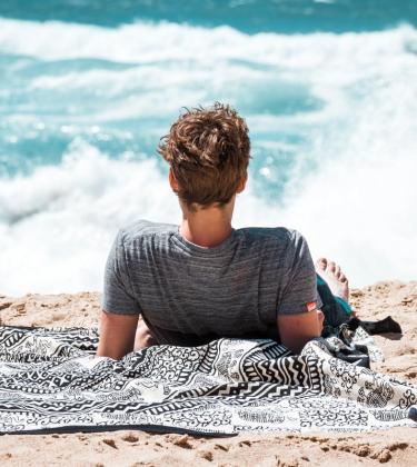 man on beach summer skincare