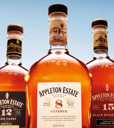 Five bottles of Appleton Estate rum in a field