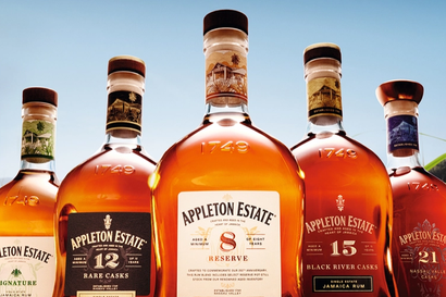 Five bottles of Appleton Estate rum in a field