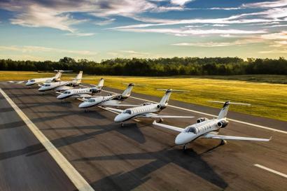 A row of Cessna Citation business jets lined up on a runway