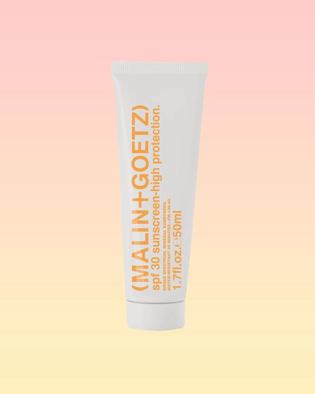 Malin+Goetz SPF 30 Sunscreen–High Protection bottle on a pink and yellow background