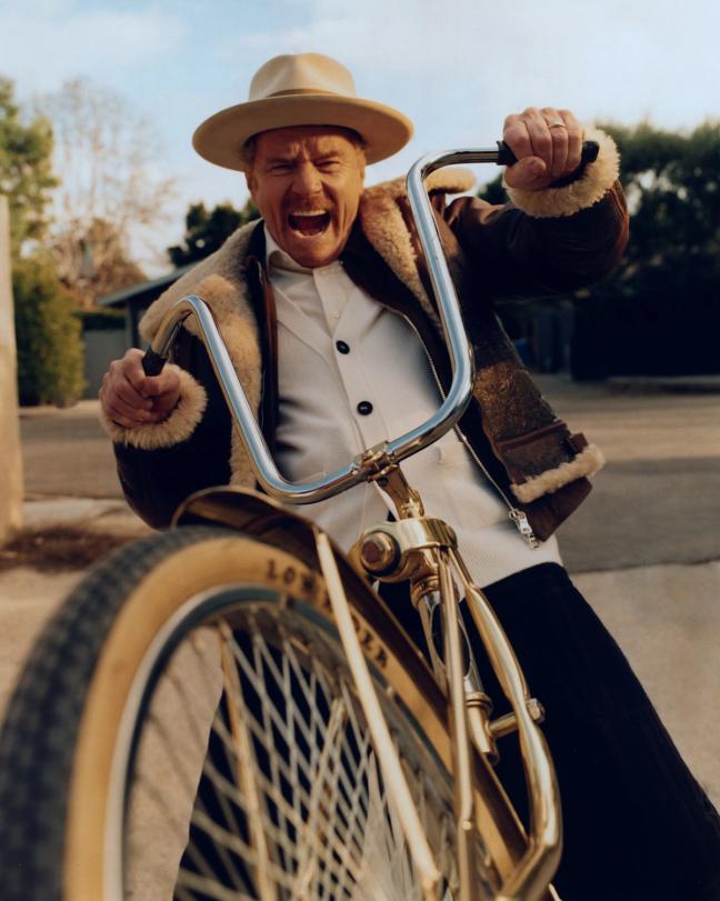 Bryan Cranston in Nick Fouquent Hat riding a chopper bike