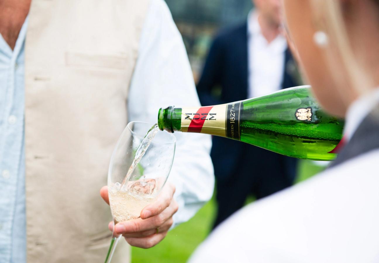 Glass of Mumm champagne being poured