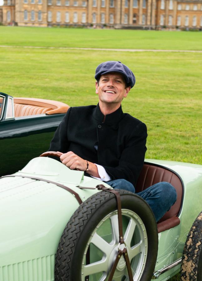Alexander Spencer-Churchill sat in a small classic car