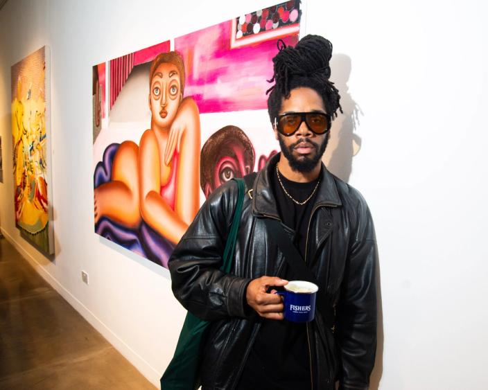 Venner James in-front of gallery art