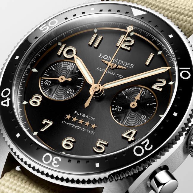 The face of a Longines Spirit Flyback watch with black dial and fabric strap