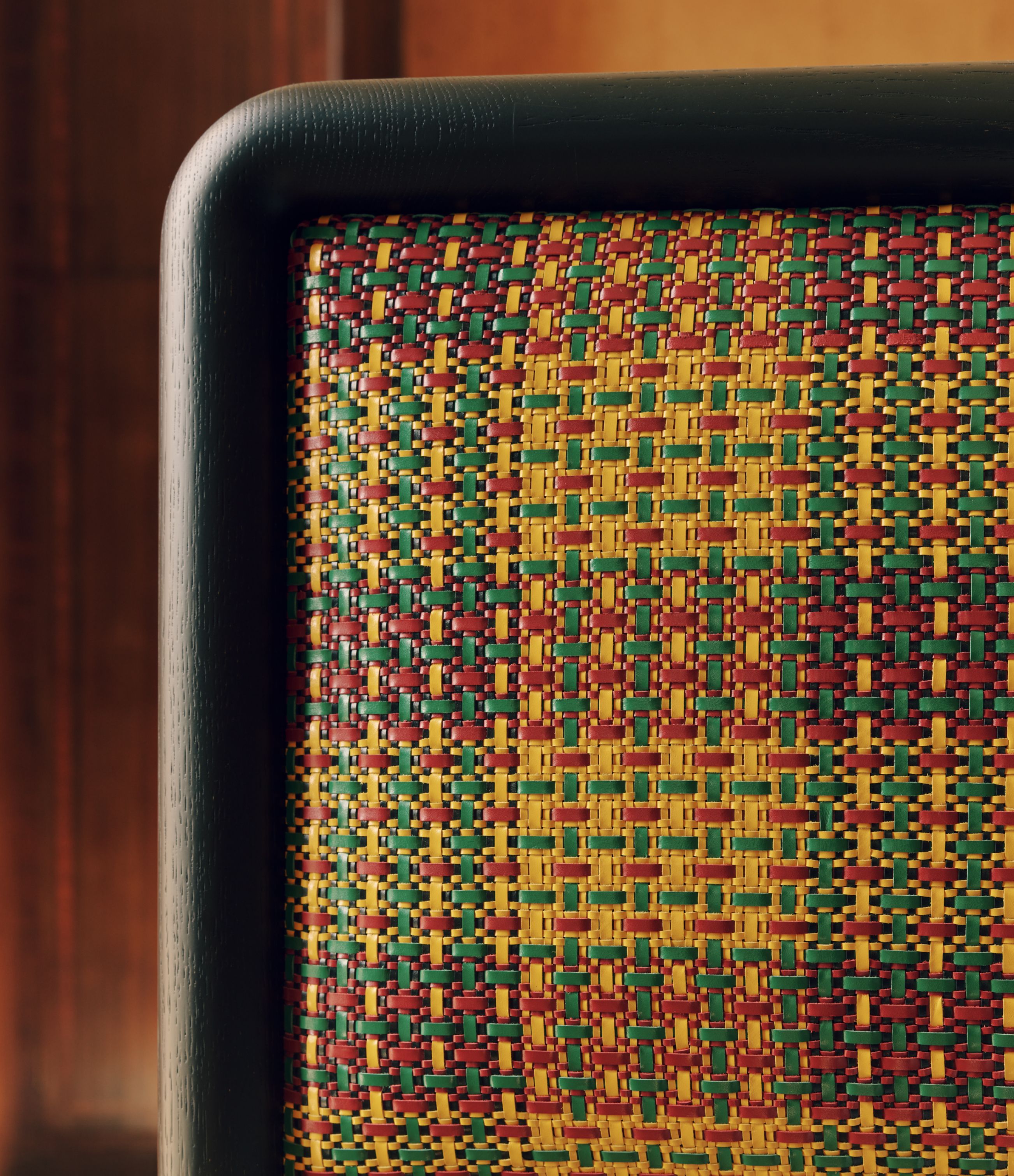 The woven-leather headboard draws on the geometry of traditional Ghanaian Kente cloth.