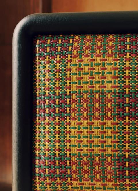 The woven-leather headboard draws on the geometry of traditional Ghanaian Kente cloth.