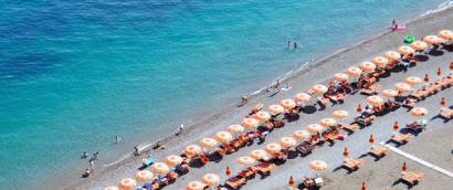 Positano Beach with rows of orange umbrellas on the Amalfi Coast