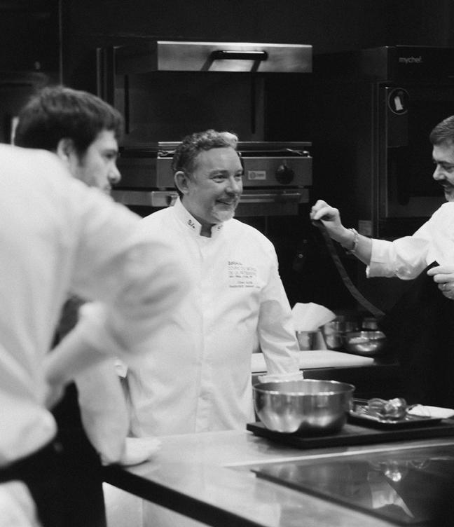 A black and white photo of Albert Adria in the kitchen