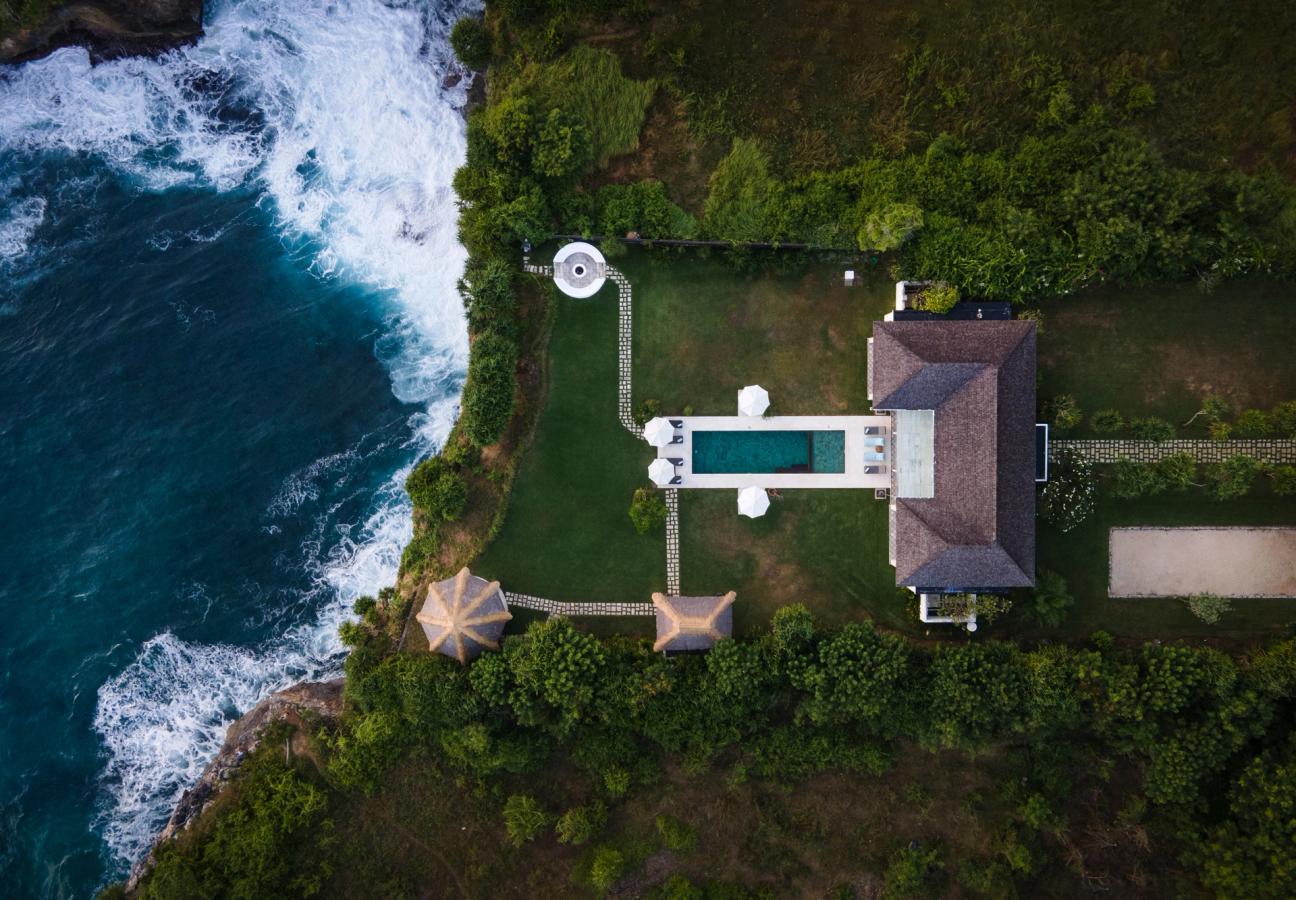 Aerial view of the clifftop villa and pool beside the ocean on Nusa Lembongan
