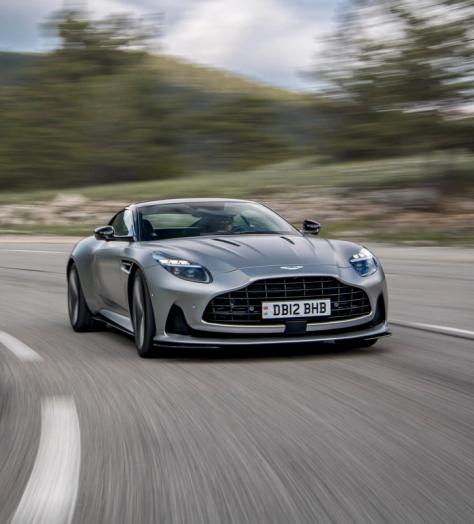 Silver Aston Martin DB12 driving on the road