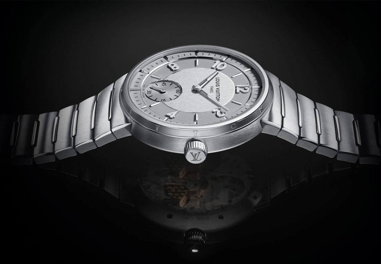 Crown of the Louis Vuitton Tambour Automatic 40mm Steel watch on a black back drop