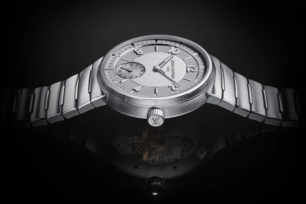 Crown of the Louis Vuitton Tambour Automatic 40mm Steel watch on a black back drop