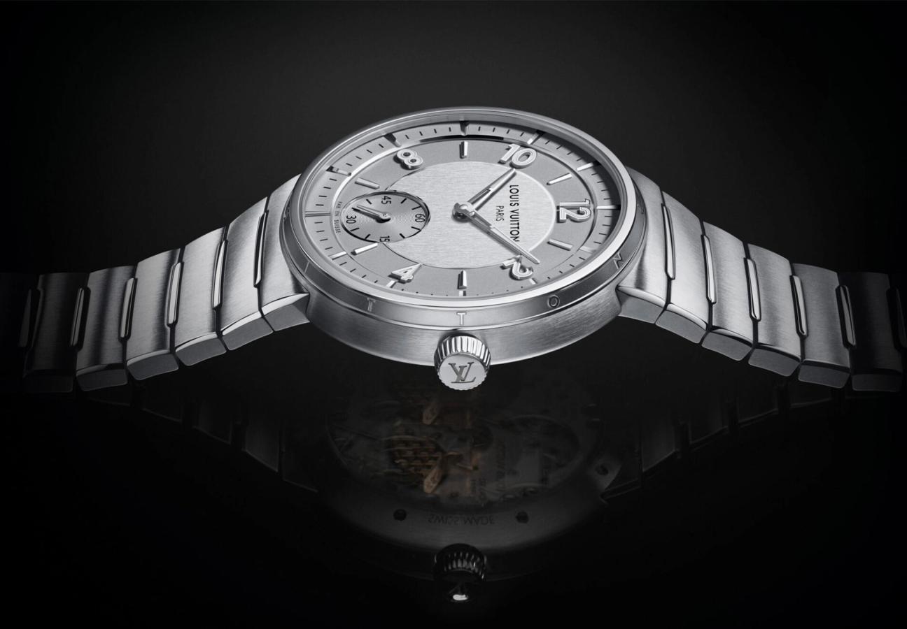 Crown of the Louis Vuitton Tambour Automatic 40mm Steel watch on a black back drop