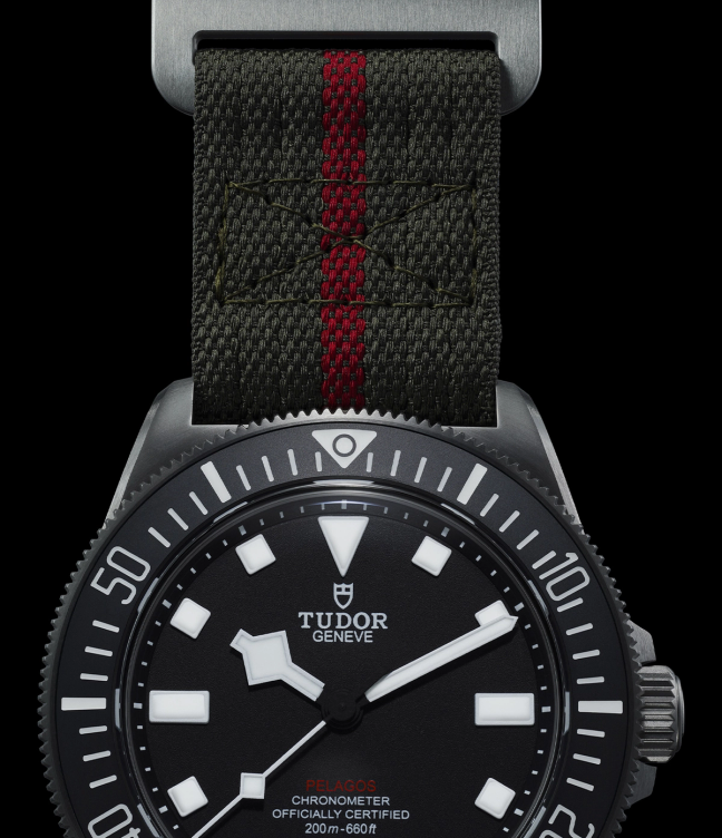 A close up of a Tudor Pelagos FXD watch on a black background