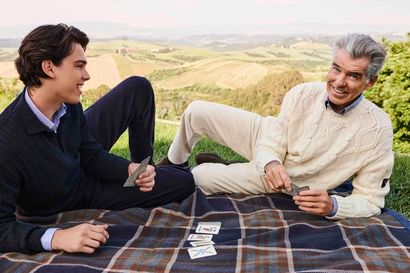 Pierce Brosnan and his son Paris Brosnan playing cards on a picnic blanket wearing Paul&Shark’s jumpers