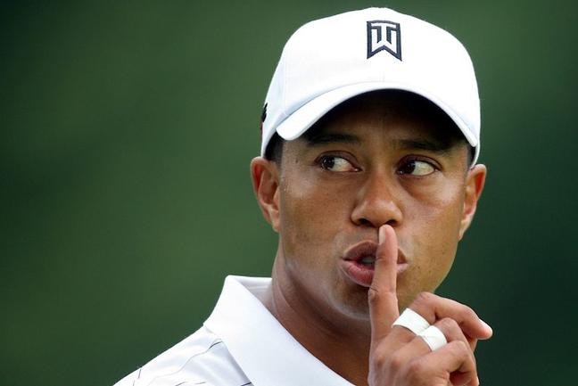 Tiger Woods of the United States gestures to a fan to be quiet from the fifth green during first round play at the WGC Bridgestone Invitational golf tournament in Akron, Ohio August 6, 2009.  REUTERS/Aaron Josefczyk (UNITED STATES SPORT GOLF) - RTR26GXI