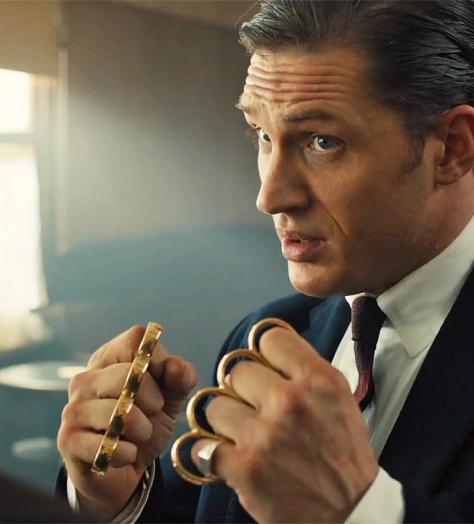 Tom Hardy with clenched fists held up wearing knuckle dusters