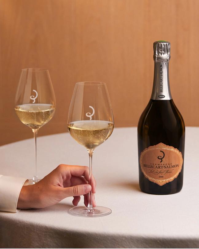 Clos Saint-Hilaire bottle and champagne glasses at the table