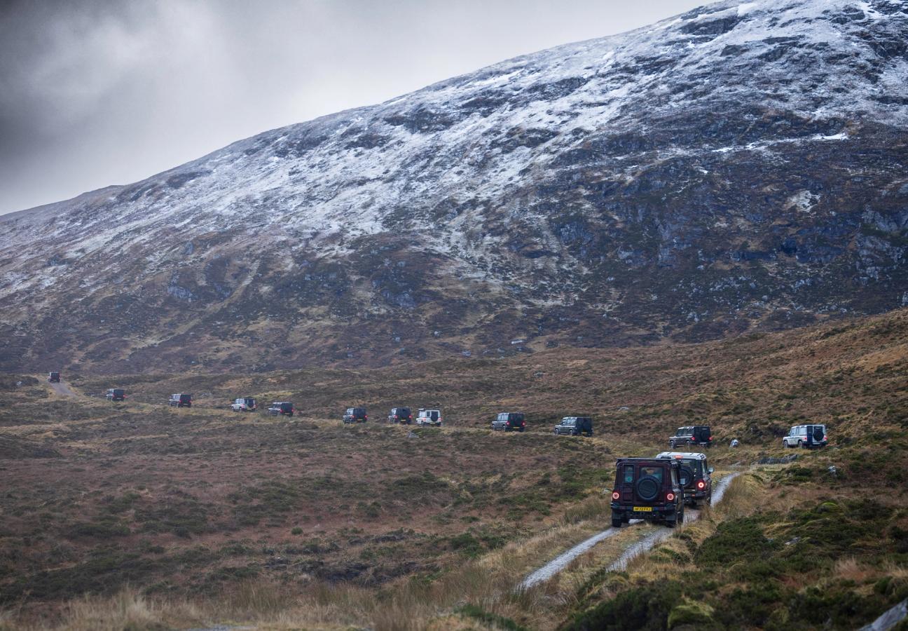 Ineos Grenadiers driving on roads at base of mountain