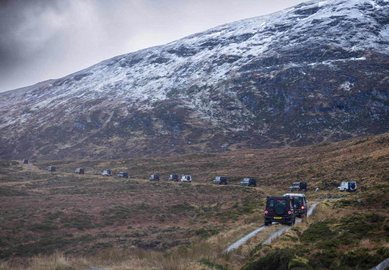 Ineos Grenadiers driving on roads at base of mountain