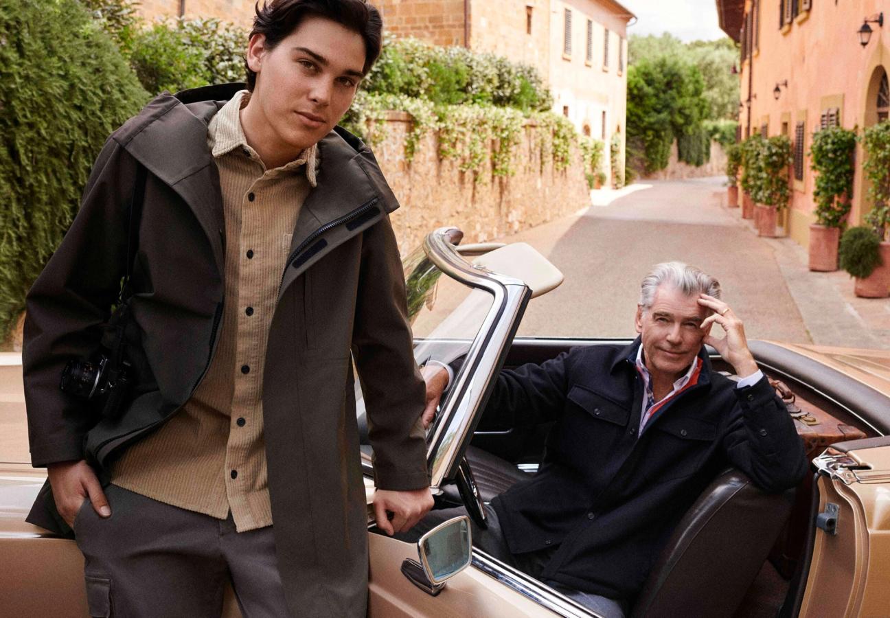 Pierce Brosnan sat in a convertible car with his son Paris Brosnan leaning against the car wearing Paul&Shark’s jackets