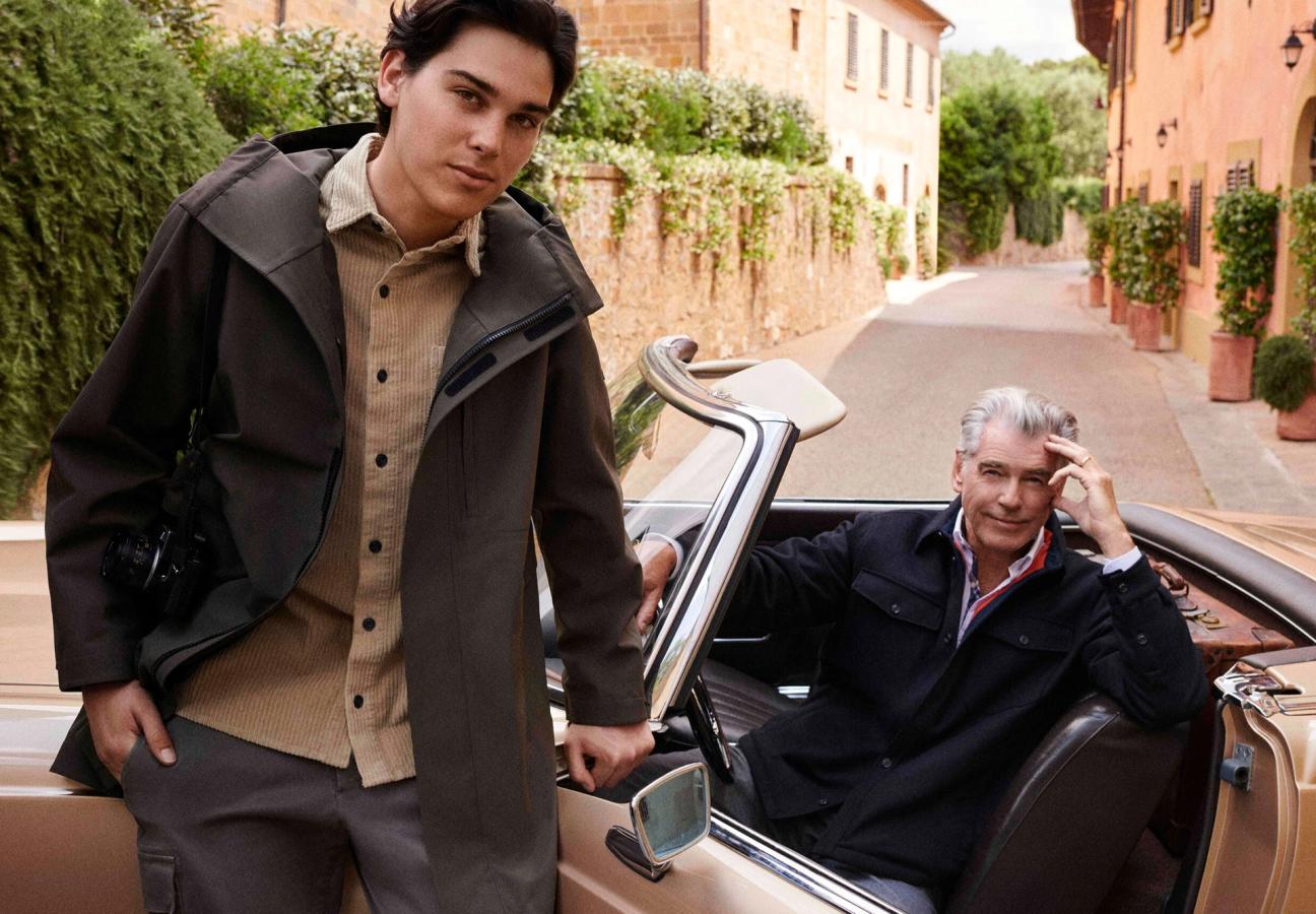 Pierce Brosnan sat in a convertible car with his son Paris Brosnan leaning against the car wearing Paul&Shark’s jackets