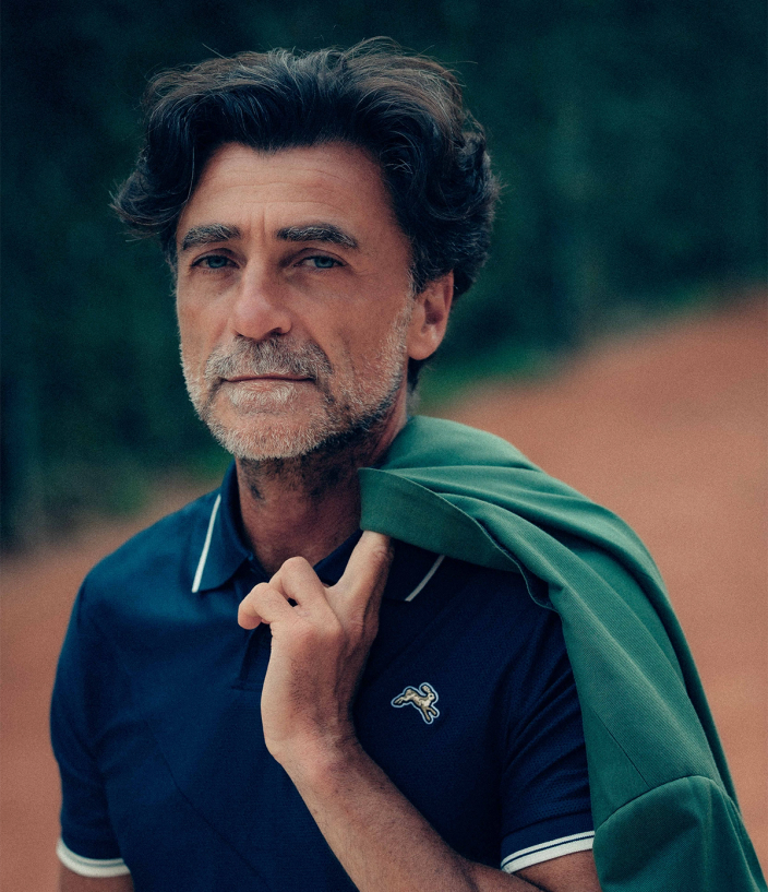 Tommaso Capozzoli, holding a blazer over Tracksmith clothing