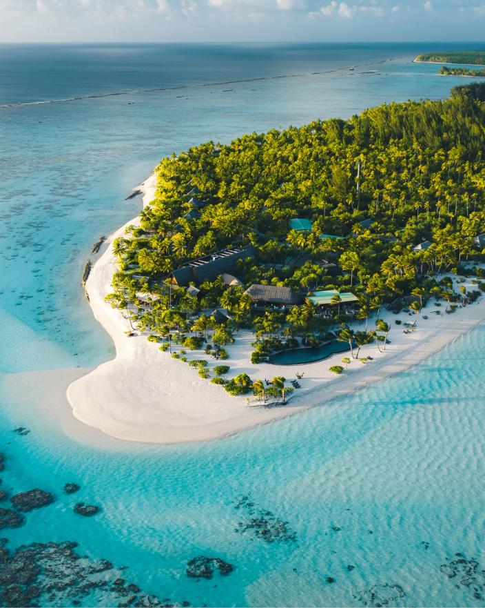 Aerial view of the palm-fringed island and lagoon at The Brando