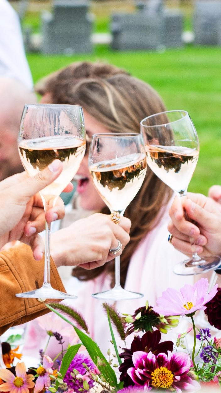 Champagne glasses are raised for a toast