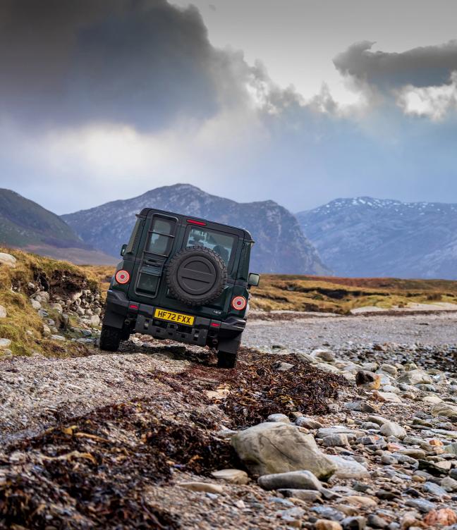 Ineos Grenadier driving over rubble and rocky terrain
