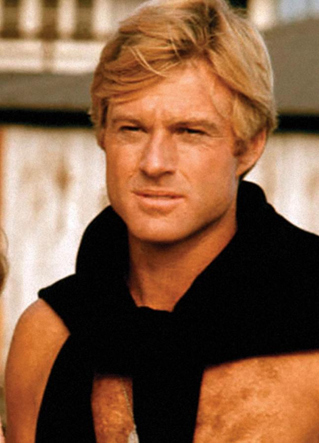 A shirtless Robert Redford wears a jumper over shoulders on the set of The Way We Were, Los Angeles, 1972