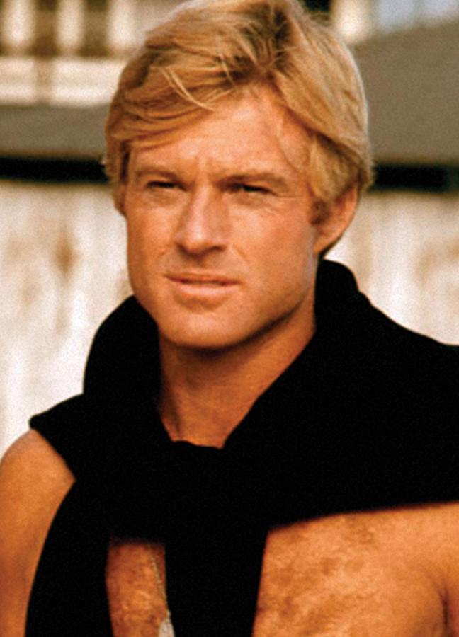 A shirtless Robert Redford wears a jumper over shoulders on the set of The Way We Were, Los Angeles, 1972