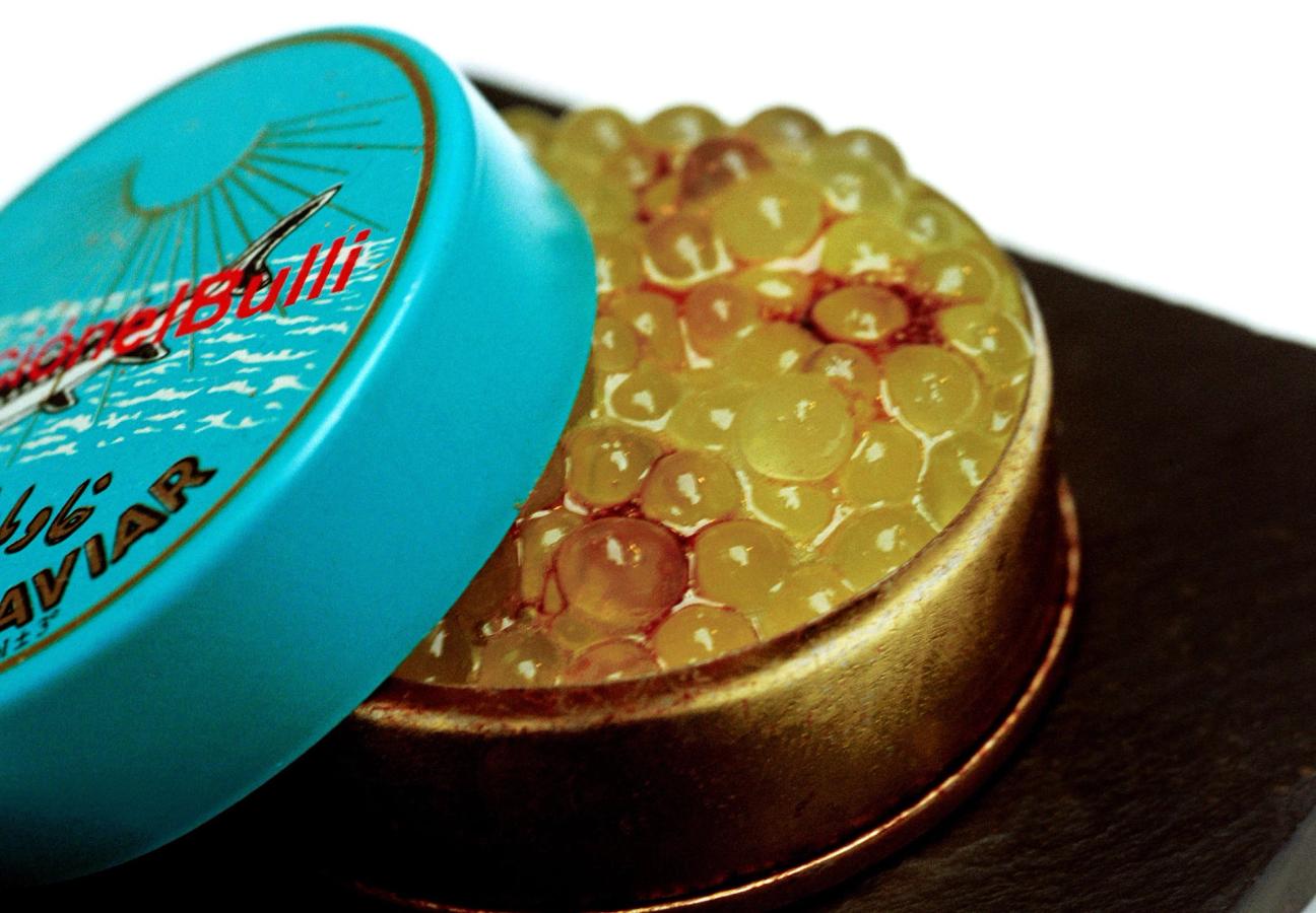 Spherified melon caviar in a caviar tin