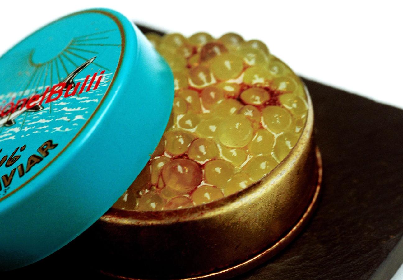 Spherified melon caviar in a caviar tin