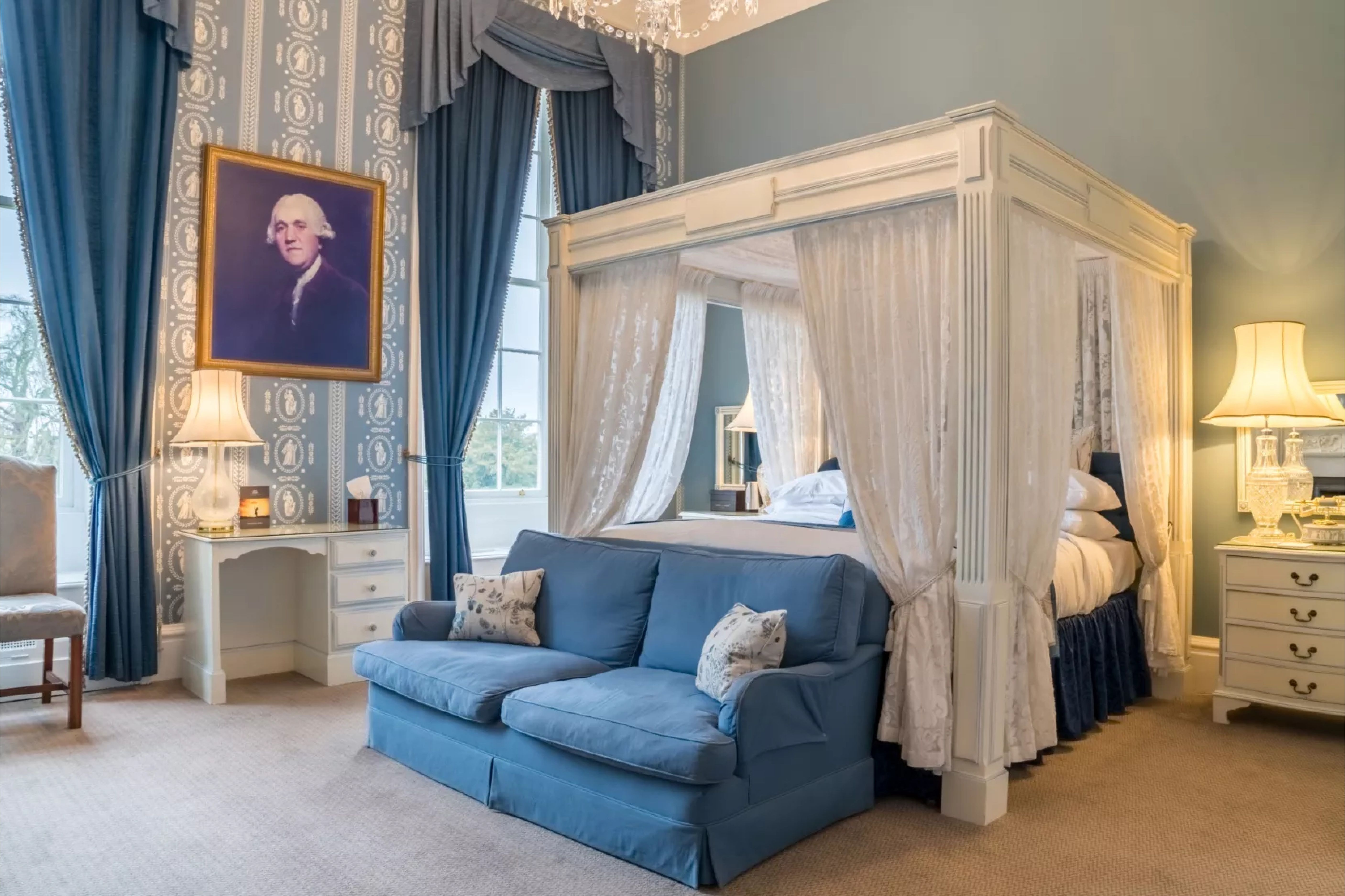 Four-poster bedroom with blue upholstery at Stapleford Park