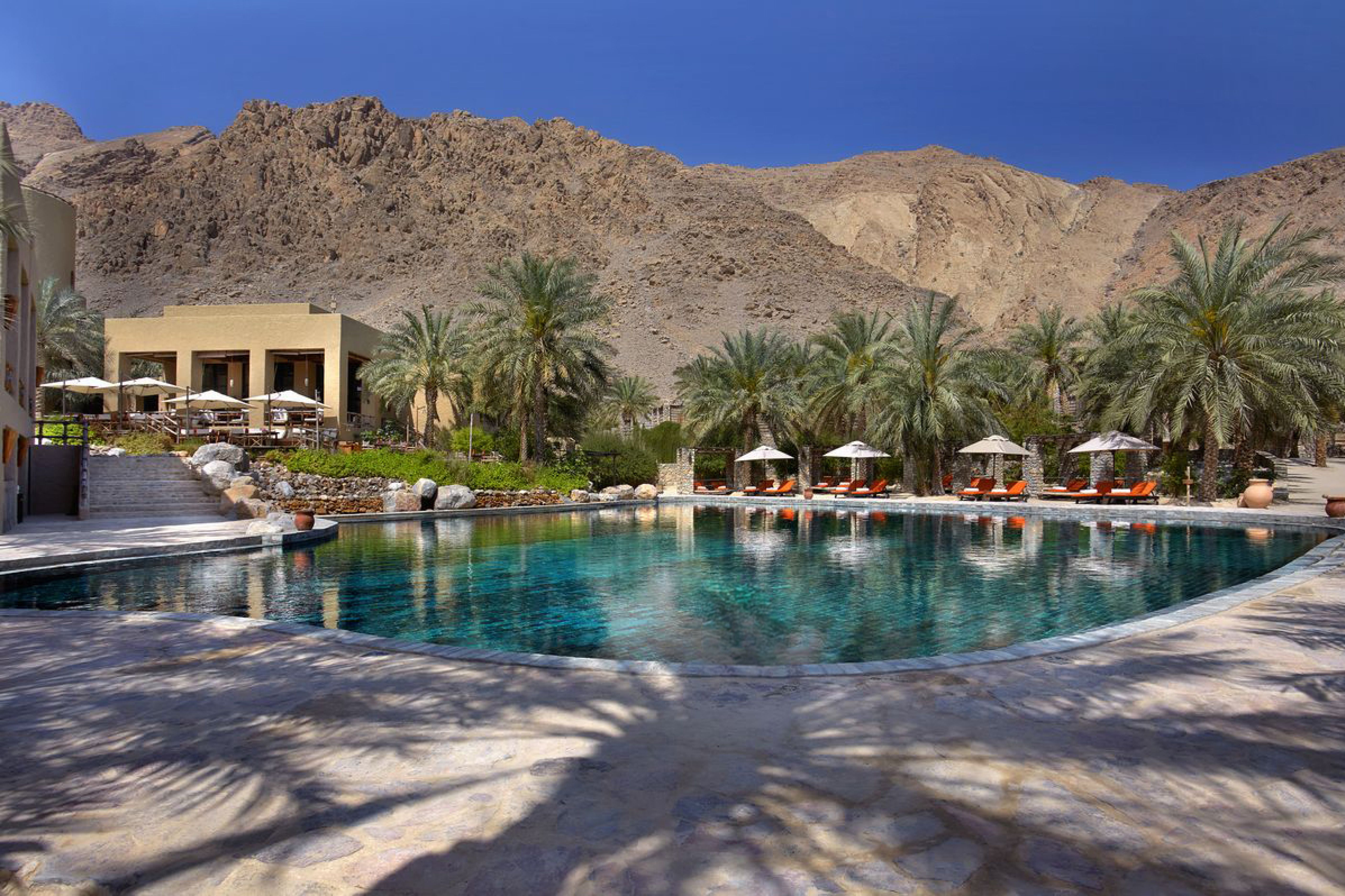 Pool beneath the mountains at Six Senses Zighy Bay